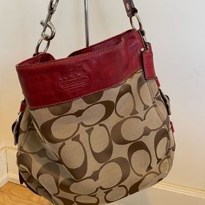 Signature Coach bag with red leather trim.